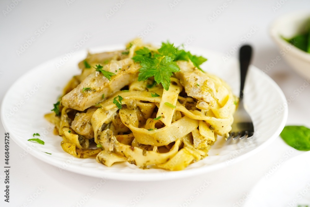 Homemade fettuccine chicken Alfredo pasta on white background Homemade fettuccine chicken Alfredo pasta on white background