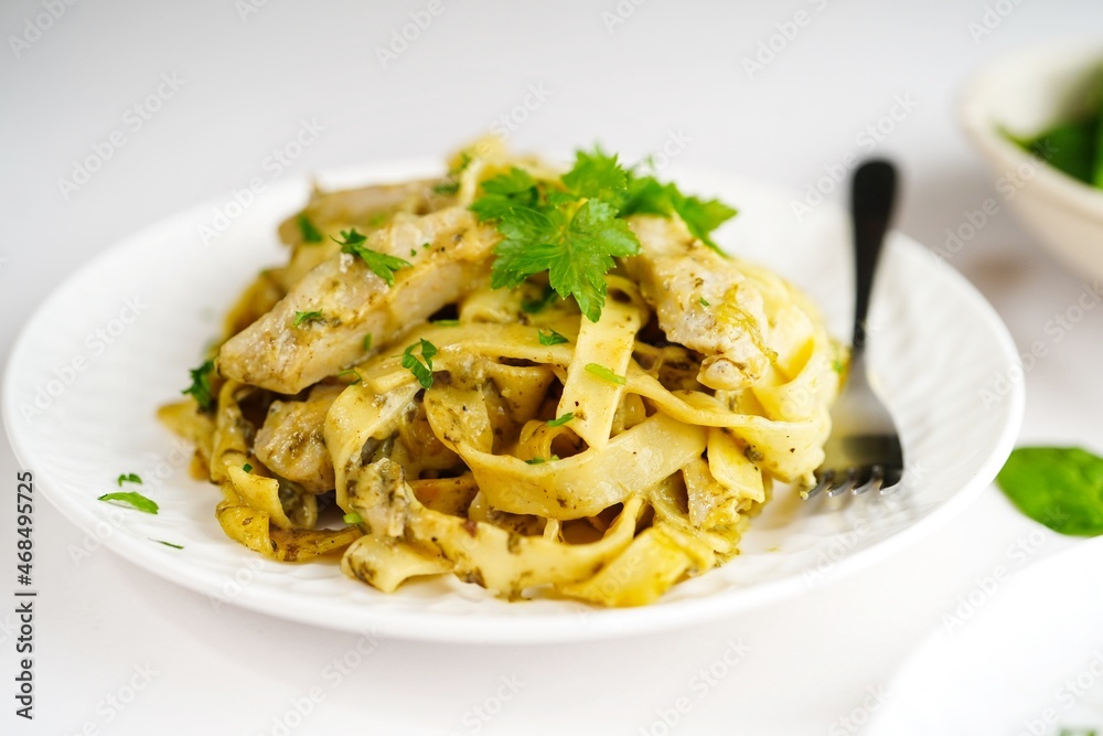 Homemade fettuccine chicken Alfredo pasta on white background