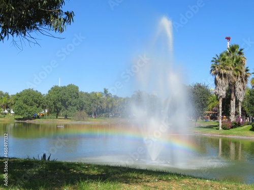 fountain with rainbow in a park © Saule