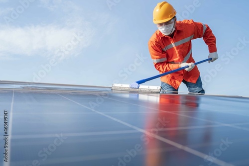 (Selective focus)Electrical engineers with helmet and mask are checking, installing,maintenance,cleaning photovoltaic plant in solar power station alternative nature energy