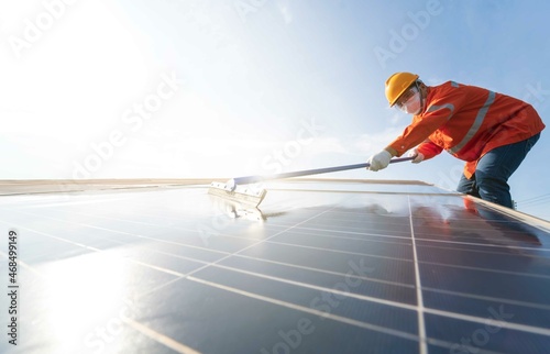 (Selective focus)Electrical engineers with helmet and mask are checking, installing,maintenance,cleaning photovoltaic plant in solar power station alternative nature energy