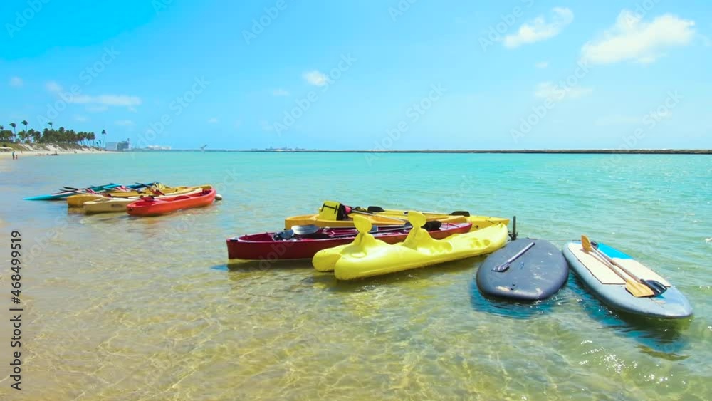 View of a beautiful beach with tourist kayaks on a sunny day. Muro Alto beach at Ipojuca, PE, Brazil. Tourist destination of Pernambuco state, brazilian northeast. View of a beautiful beach with tourist kayaks on a sunny day. Muro Alto beach at Ipojuca, PE, Brazil. Tourist destination of Pernambuco state, brazilian northeast.