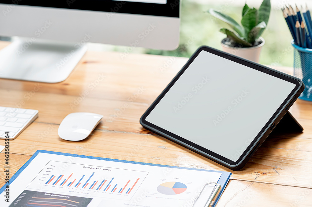 blank screen tablet and paperwork on wooden table. blank screen tablet and paperwork on wooden table.
