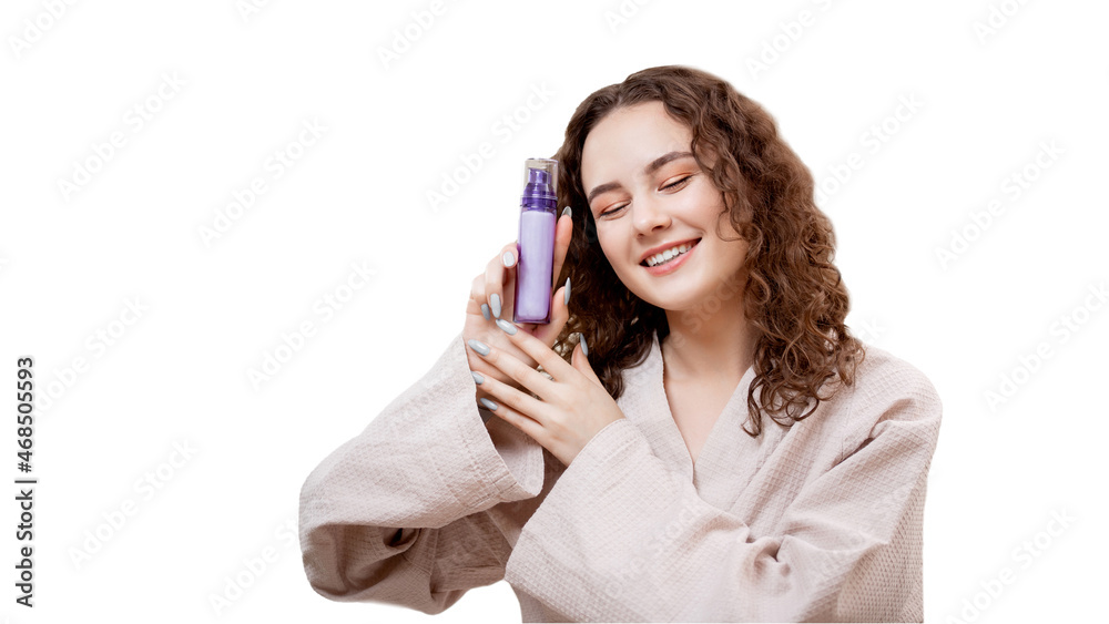 Happy young curly woman holding bottle with beauty skin care product isolated white. Concept cosmetology against acne Happy young curly woman holding bottle with beauty skin care product isolated white. Concept cosmetology against acne