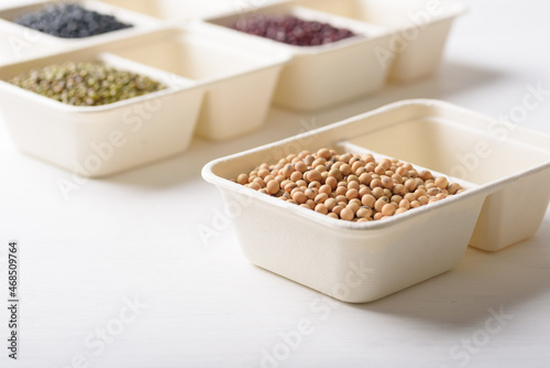 Soybeans in compostable cardboard boxes are eco-friendly concepts and are mainly used as a plant-based ingredient in vegetarian  healthy food.