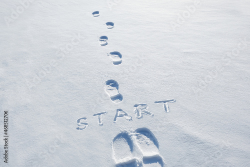 Concept inscription start and footprints in snow. New Year. Beginning. first step