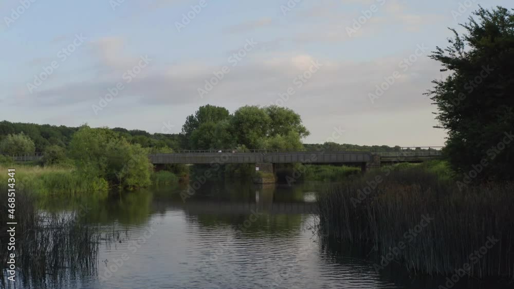 Aerial view of a scenic meadow intersected by a beautiful river and surrounded by a dark forest. Aerial view of a scenic meadow intersected by a beautiful river and surrounded by a dark forest.