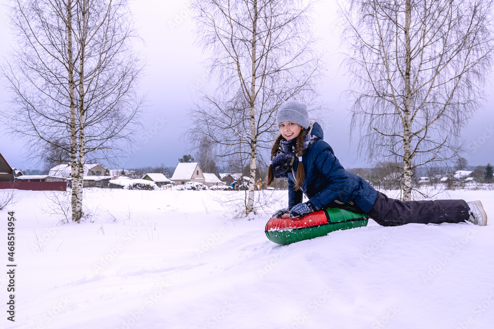 Beautiful girl rides downhill in winter