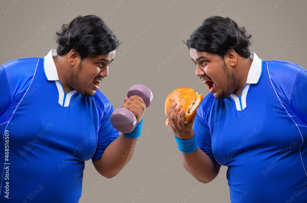 Contrast of fat man holding dumbles against him eating burger.
