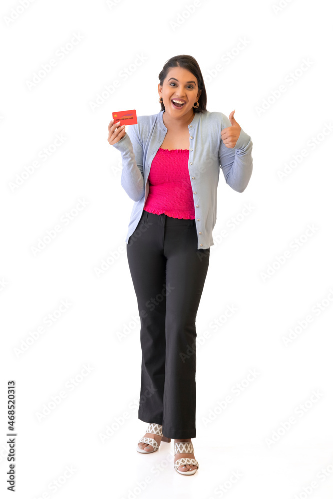 Happy Indian girl posing in front of camera with debit card Happy Indian girl posing in front of camera with debit card
