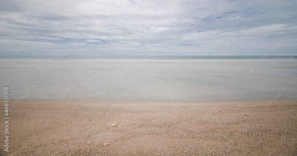 timelapse the beach with white sand and wave from peaceful sea in sunshine daytime timelapse the beach with white sand and wave from peaceful sea in sunshine daytime