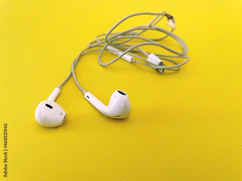 earbuds on yellow background earbuds on yellow background