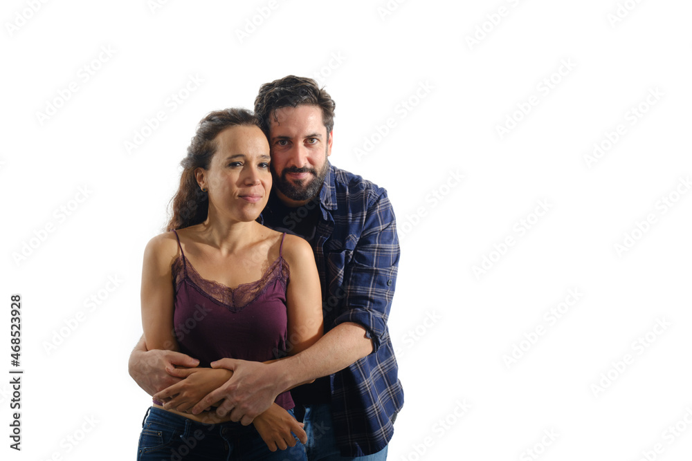 Lovely and happy couple hugging while standing over an isolated background. Lovely and happy couple hugging while standing over an isolated background.