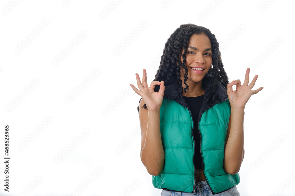 Positive woman showing OK gesture with both hands while standing on isolated background. Positive woman showing OK gesture with both hands while standing on isolated background.