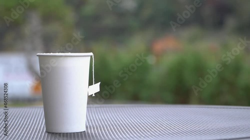 4k, full shot, Tea in a white paper cup. Tea that's steaming up photo