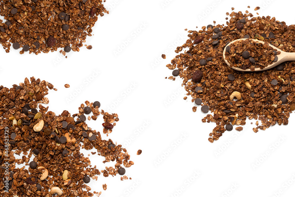Chocolate granola cereal with nuts in a wooden spoon. Chocolate granola cereal with nuts in a wooden spoon.