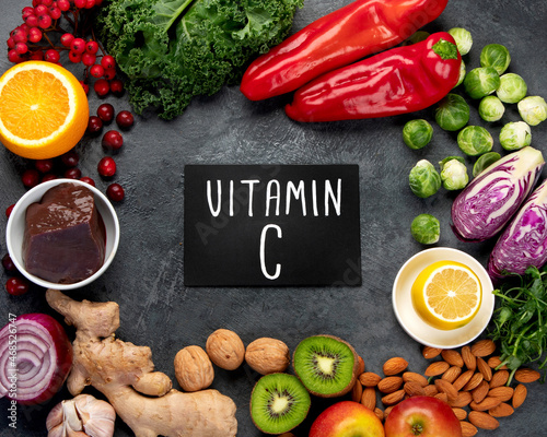 Foods high in vitamin C on dark background.