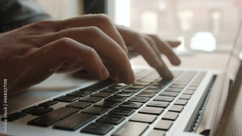 Man's hands typing on laptop keyboard Man's hands typing on laptop keyboard