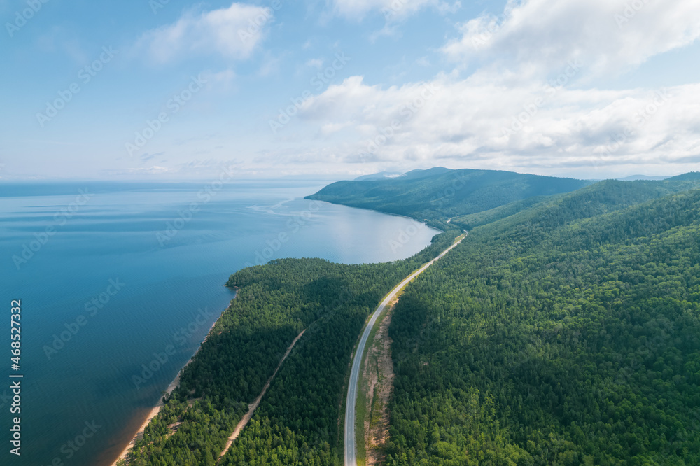 Summertime imagery of Lake Baikal is a rift lake located in southern Siberia, Russia Baikal lake summer landscape view from a cliff near Grandma's Bay. Drone's Eye View. Summertime imagery of Lake Baikal is a rift lake located in southern Siberia, Russia Baikal lake summer landscape view from a cliff near Grandma's Bay. Drone's Eye View.