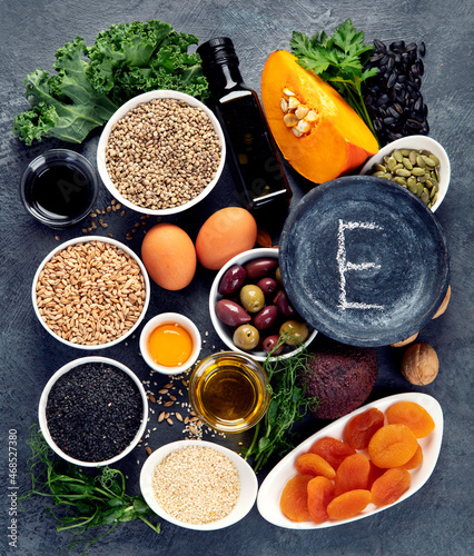 Foods high in vitamin E on dark background.