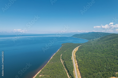 Summertime imagery of Lake Baikal is a rift lake located in southern Siberia, Russia Baikal lake summer landscape view from a cliff near Grandma's Bay. Drone's Eye View. © Quatrox Production