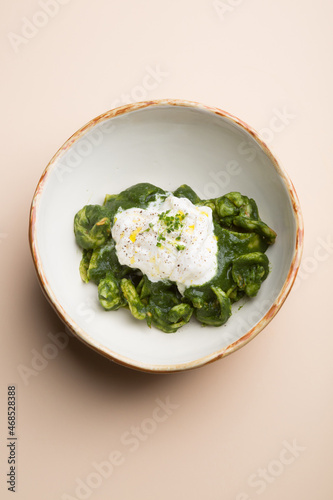 Obraz na płótnie Round italian ravioli pasta served with green basil sauce and cheese w salonie