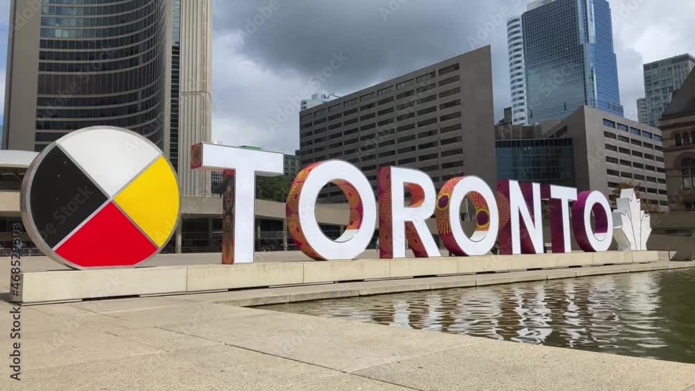 3D Toronto Sign and water fountain feature at Nathan Phillips Square in front of City Hall; 4K 60fps