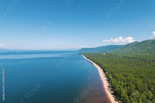 Summertime imagery of Lake Baikal is a rift lake located in southern Siberia, Russia Baikal lake summer landscape view from a cliff near Grandma's Bay. Drone's Eye View.