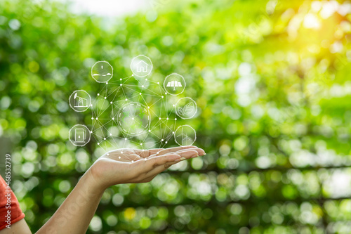 Technology, hand holding with environment Icons over the Network connection on green background