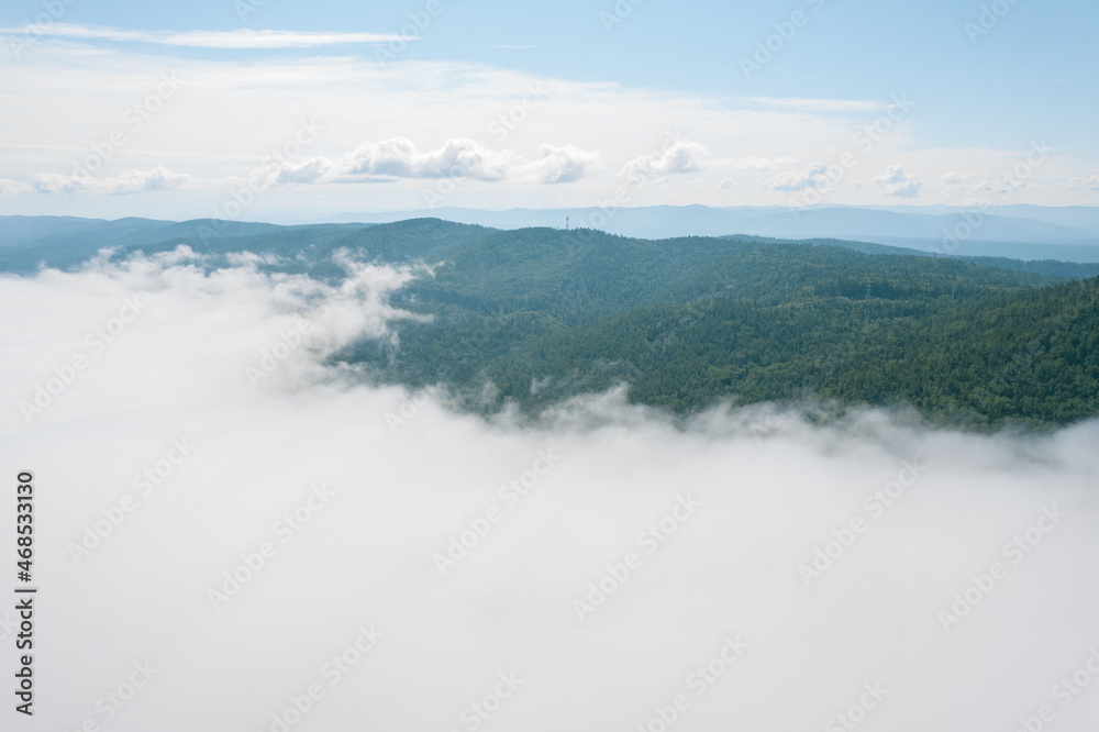 Flying through the clouds above mountain tops. High peaks wonderful morning sunrise natural Landscape