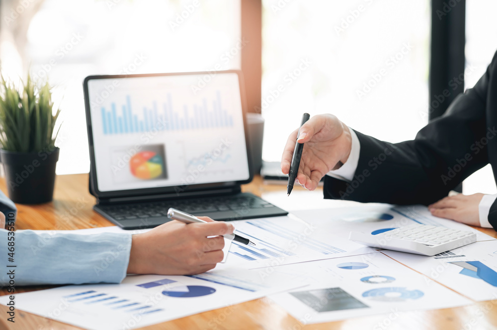 Business people hands working on business graph and chart at office. Business people hands working on business graph and chart at office.