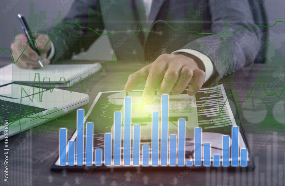 Businessman working in financial graphs.