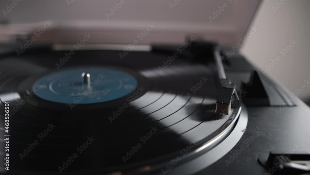 Black vinyl Retro spinning record on turntable. blue screen in center. Rotating plate close up. Party. Loop. close View from above Popular Disco Trends 60s, 70s, 80s, 90s Black vinyl Retro spinning record on turntable. blue screen in center. Rotating plate close up. Party. Loop. close View from above Popular Disco Trends 60s, 70s, 80s, 90s