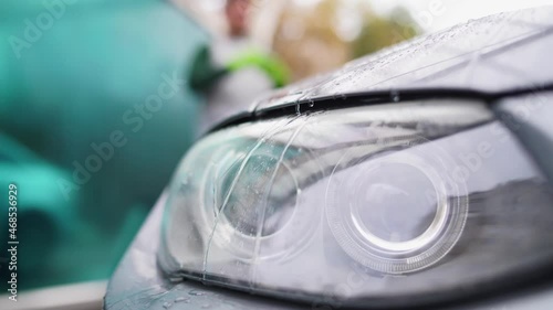 close-up of an auto headlight.Head light of BMW E92 with raindrops on close up