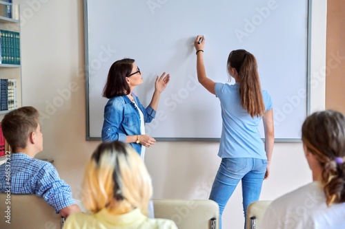 Lesson in classroom with digital screen for group of teenagers