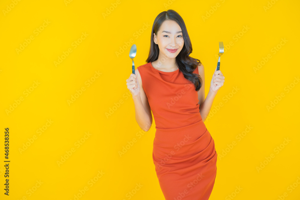 Portrait beautiful young asian woman smile with spoon and fork