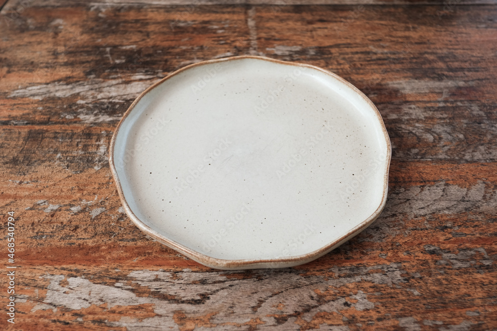 Empty ceramic shape plate for food on wooden table rustic background Empty ceramic shape plate for food on wooden table rustic background
