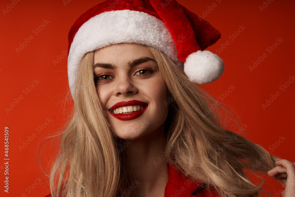 pretty woman in santa hat smile cosmetics glamor red background pretty woman in santa hat smile cosmetics glamor red background