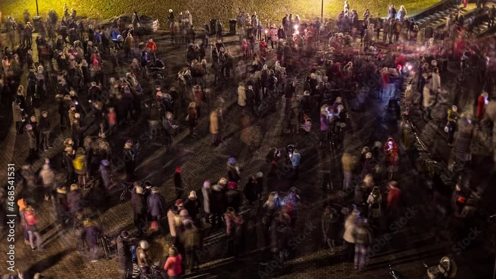 Crowd Standing In The Street At Night During Proclamation Day of the Republic of Latvia. - timelapse