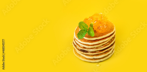 stack of freshly home made pancakes isolated over bright yellow background, traditional americal breakfast meal, studio photo shot. High quality photo photo