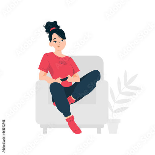 Woman playing console while sitting in a chair