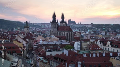 Day to night sunset timelapse of the Prašná Brána (Powder Tower), Old Town Hall, Prague Castle and downtown Prague, Czech Republic as it lights up during the night photo