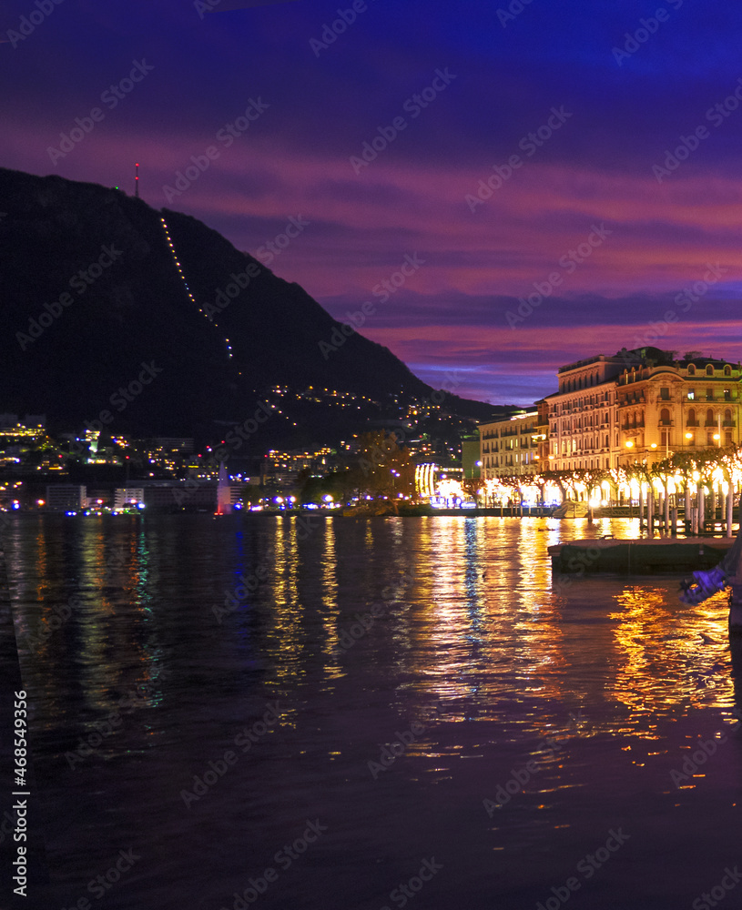 Lugano by night, cityscape from the lakefront. Lugano lake, Switzerland.