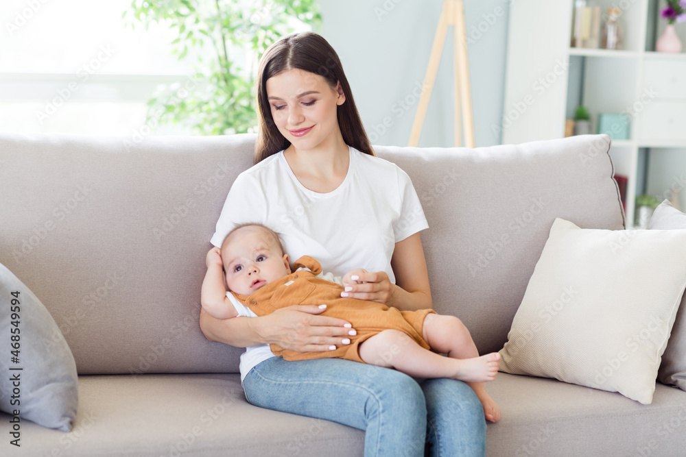 Photo of inspired babysitter charming redhead lady cuddle infant baby boy wear white t-shirt home indoors Photo of inspired babysitter charming redhead lady cuddle infant baby boy wear white t-shirt home indoors