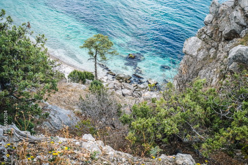 View from the mountain to a small beach near the rock Diva in the resort black sea village Simeiz. Cloudy autumn day