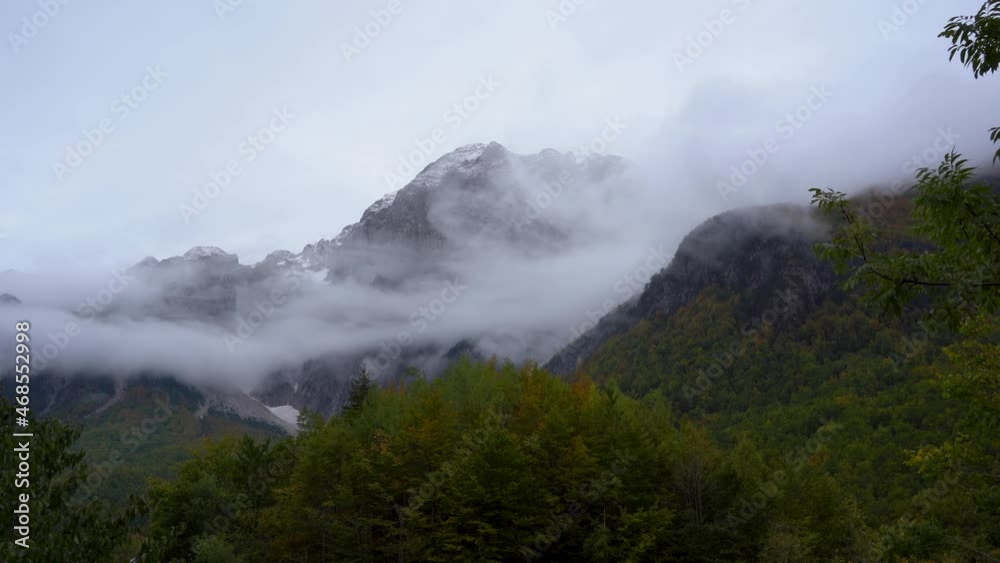 Fog covering high mountains in Alps after the first snow, timelapse of misty scenery in Balkans Fog covering high mountains in Alps after the first snow, timelapse of misty scenery in Balkans