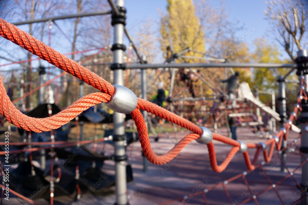 Children's playground for active games. A slide of ropes as a device for climbing up. Close-up of cables and ropes Children's playground for active games. A slide of ropes as a device for climbing up. Close-up of cables and ropes