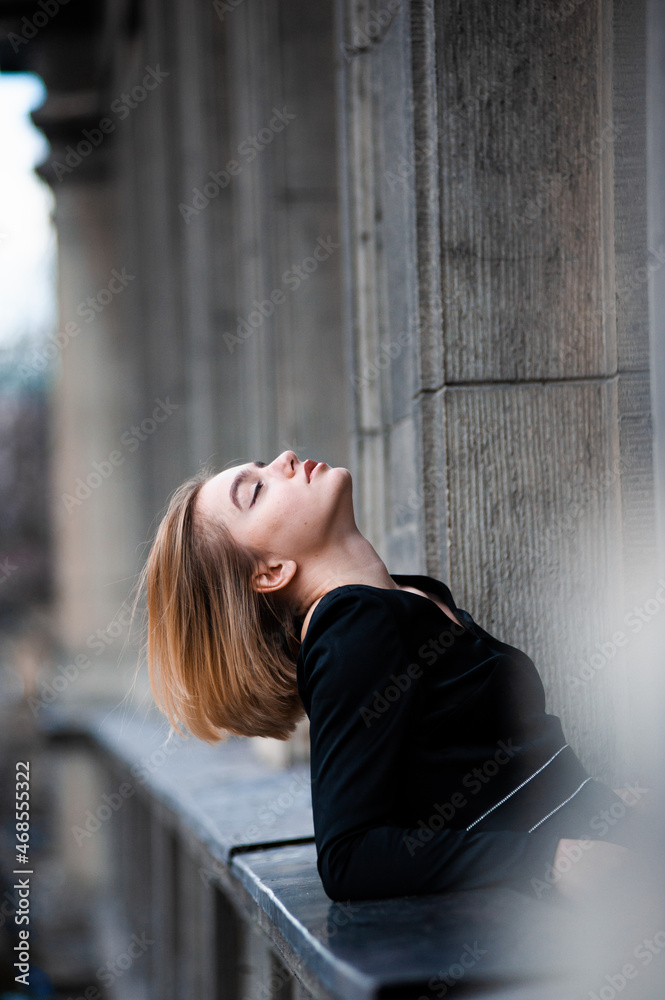 Fototapeta premium Young woman on the city balcony