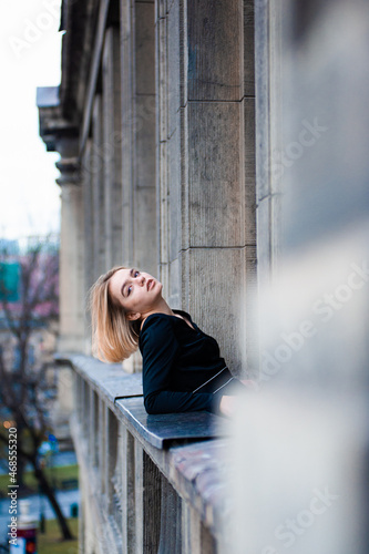 Young woman on the city balcony