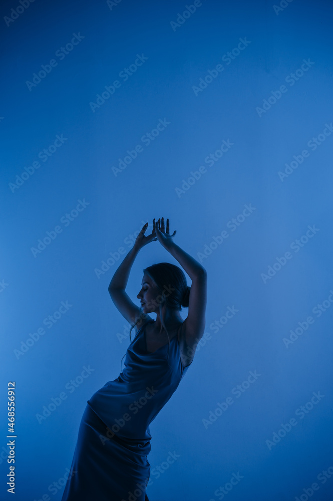 beautiful girl in a dress, blonde hair, dancing on a colored background with a pattern beautiful girl in a dress, blonde hair, dancing on a colored background with a pattern